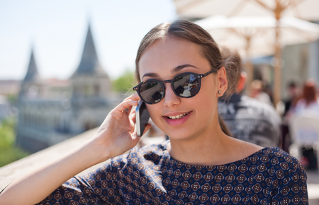 Outdoors portrait of happy young brunette tourist woman.の写真素材