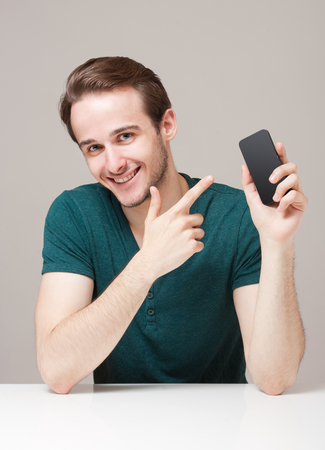 Portrait of a friendly smiling handsome young brunette man.の写真素材