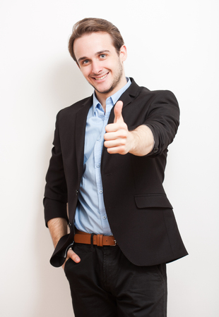 Portrait of a friendly smiling handsome young brunette man.の写真素材