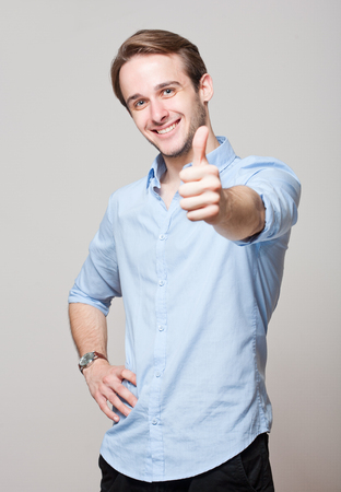 Portrait of a friendly smiling handsome young brunette man.の写真素材