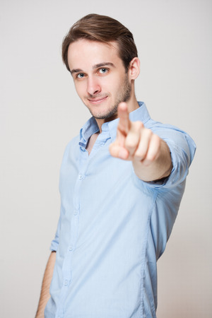 Portrait of a happy young cheerful brunette guy.の写真素材