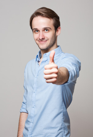 Portrait of a happy young cheerful brunette guy.の写真素材