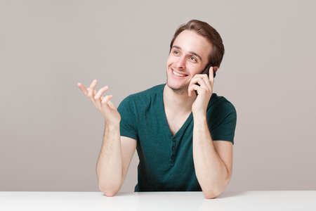 Portrait of a happy young cheerful brunette guy.の写真素材