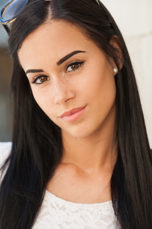 Outdoors portrait of a slender brunette summer fashion beauty.の写真素材