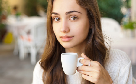 Portrait of a sweet young brunette woman in a restaurant.の写真素材