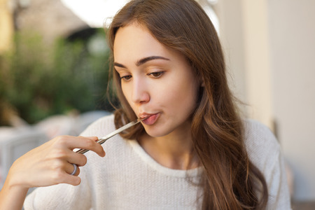 Portrait of a gorgeous young woman having gourmet fun in restaurant.の写真素材