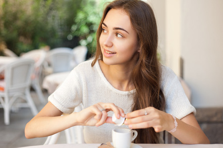 Portrait of a sweet young brunette woman in a restaurant.の写真素材
