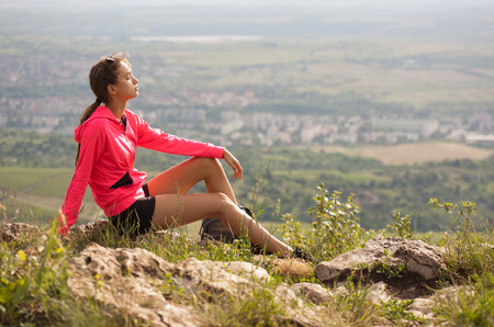 Fit young brunette woman doing outdoors exercise in fresh air.の写真素材