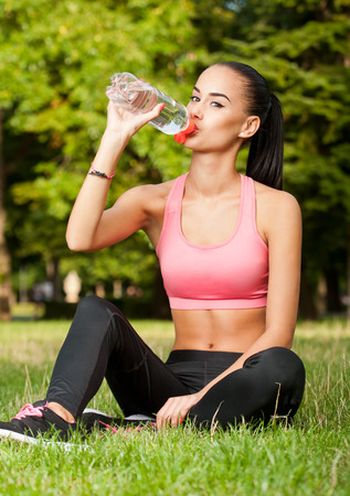 Gorgeous fit young brunette woman having some outdoors exercise.の写真素材