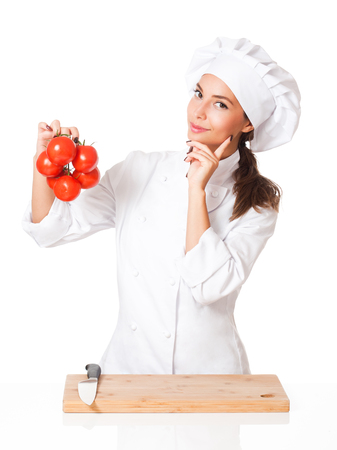 Portrait of a young brunette chef woman isolated on white background.の写真素材