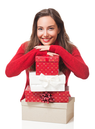Portrait of a gorgeous young brunette woman holding decorative Christmas gift boxes.の写真素材