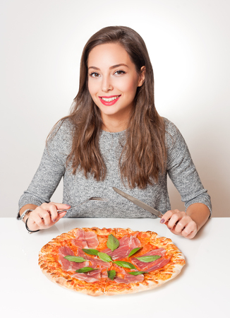 Gorgeous young brunette woman having Italian food.の写真素材