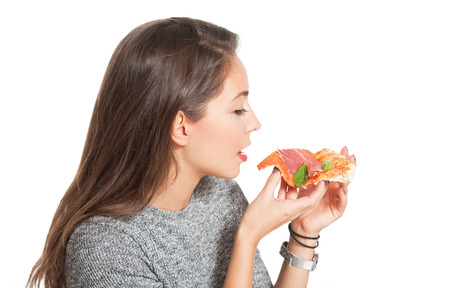 Beautiful young brunette woman eating Italian meal.の写真素材