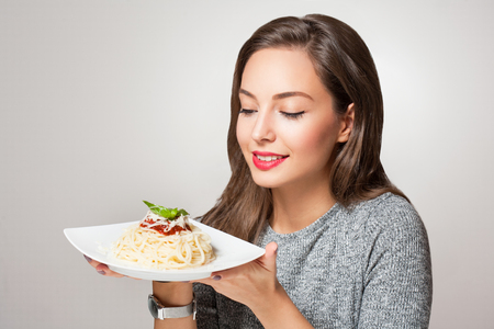 Gorgeous young brunette woman having Italian food.の写真素材