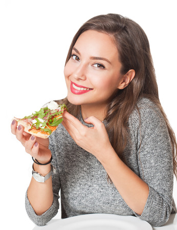 Beautiful young brunette woman eating Italian meal.の写真素材