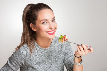 Gorgeous young brunette woman having Italian food.の写真素材
