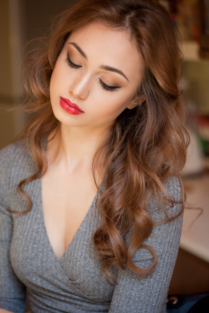 Portrait of a gorgeous brunette woman in colorful makeup.の写真素材