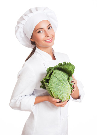 Portrait of a young brunette chef woman isolated on white background.の写真素材