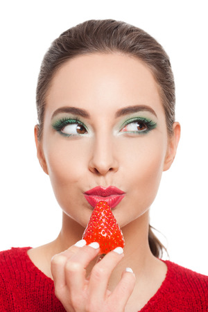 Portrait of beautiful young brunette woman with nutritious fruits.の写真素材