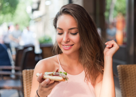 Young tourist woman having fun in a local restaurant.の写真素材