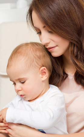 Portrait of gorgeous young mother with her infant child.の写真素材