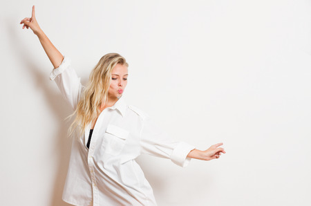 Portrait of a sensual tanned blond in white shirt.の写真素材