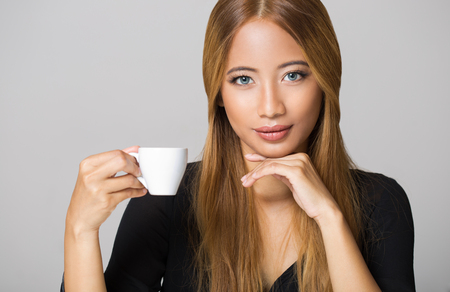 Portrait of an asian beauty having coffee.の写真素材