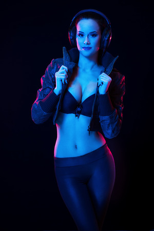 Sensual techno dancer in colorful lighting.の写真素材