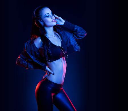 Sensual techno dancer woman in colorful club lighting.の写真素材