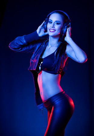 Sensual techno dancer woman in colorful club lighting.の写真素材