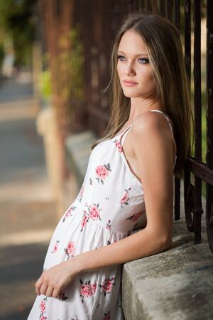 Outdoors portrait of a blond beauty in white summer dress.の写真素材