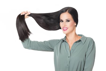 Portrait of a brunette beauty showing off amazing long hair.の写真素材