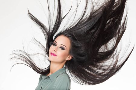 Portrait of a brunette beauty showing off amazing long hair.の写真素材
