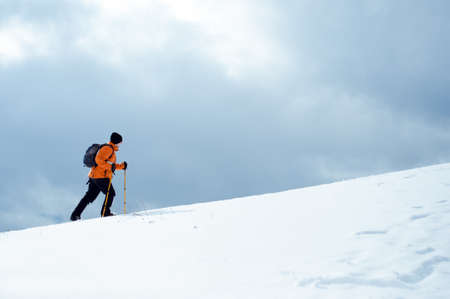 Hiker going up on a slopeの写真素材