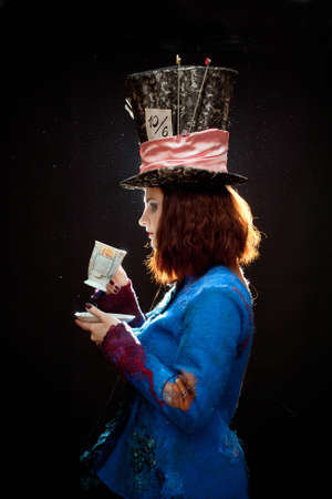 Profile of young woman in the similitude of the Hatterの写真素材