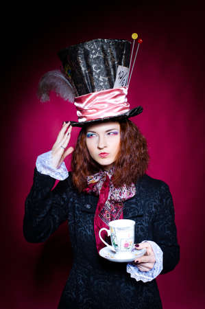 Portrait of young woman in the similitude of the Hatterの写真素材