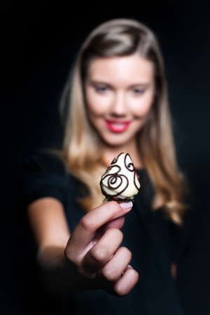 Beautiful young woman holding strawberryの写真素材