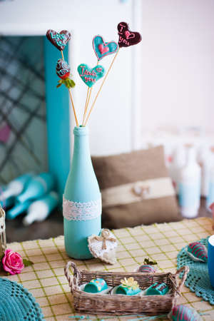 Fruit candy in a shape of heart covered by colored chocolate; Valentine's Day table decorationの写真素材