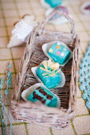 Fruit candy from banana and strawberry covered by colored chocolate with sugar hearts, flower and words "I love you"; Valentine's Day decoration; shot in shallow depth of field, central candy in a focusの写真素材