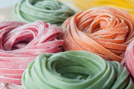Closeup of varicolored raw italian pasta; shot in shallow depth of fieldの写真素材