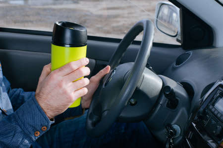 Males hand holding thermo mugの写真素材