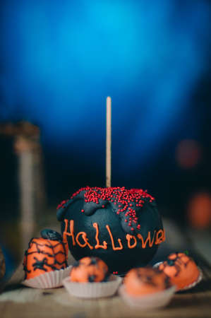 Apple covered with black chocolate; Halloween party table decorationの写真素材