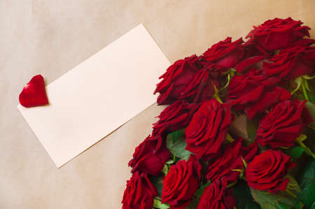 Open empty postal envelope and bouquet of rosesの写真素材