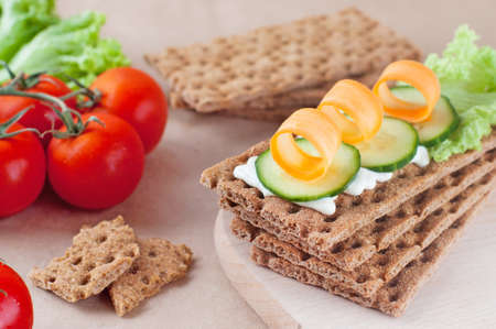 Close up of crispbreads with cheese, cucumber and carrotの写真素材
