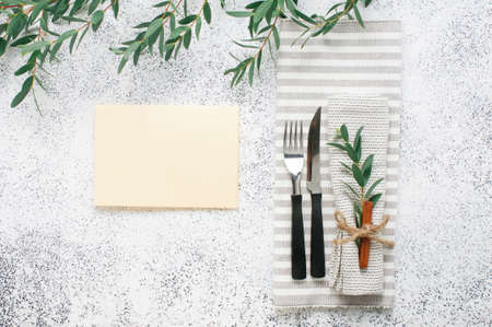 Holiday elegant table setting with linen napkin, sprig and cinnamon and empty card with blank space for text. Top view, flat lay.の写真素材