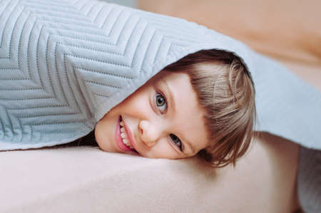 Wooden toys, clothes and shoes on green backgroundの写真素材