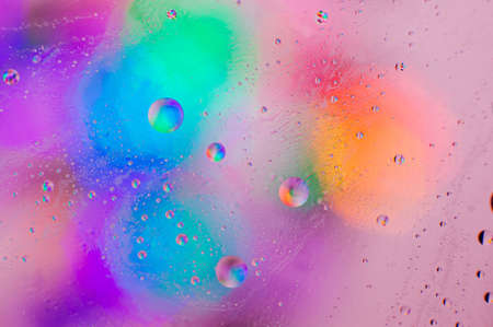 Iridescent macro background of oil drops on the water