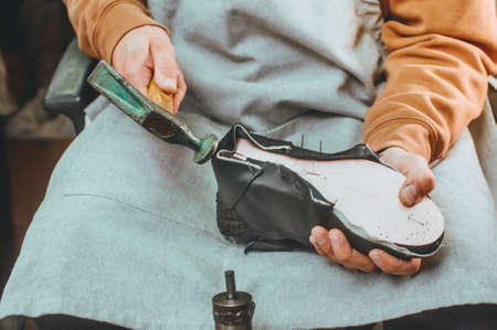 Close up of shoemaker making shoe