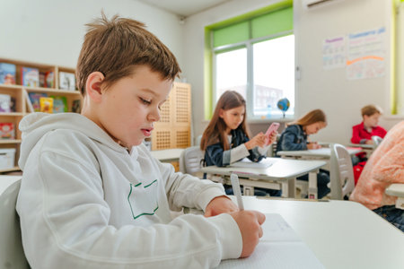 Elementary school students learning in the classroomの写真素材