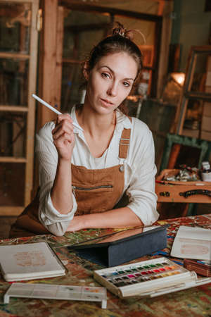 Seroius young designer holding stylus pen working on digital tabletの写真素材